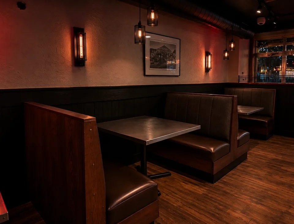 Built-in booth seating beneath warm wall lighting